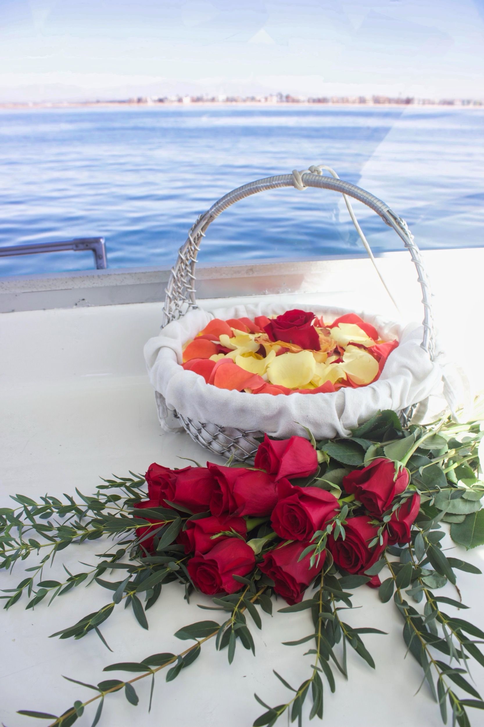A basket lined in cloth, rose petals laid above and below where the ashes go.
